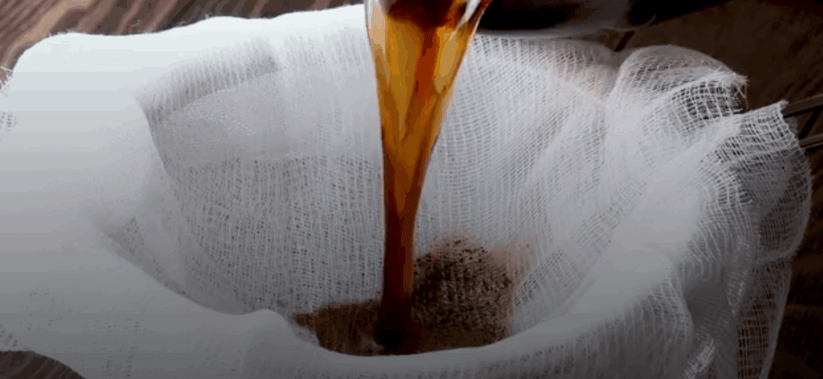 Straining the coffee through a cheesecloth.
