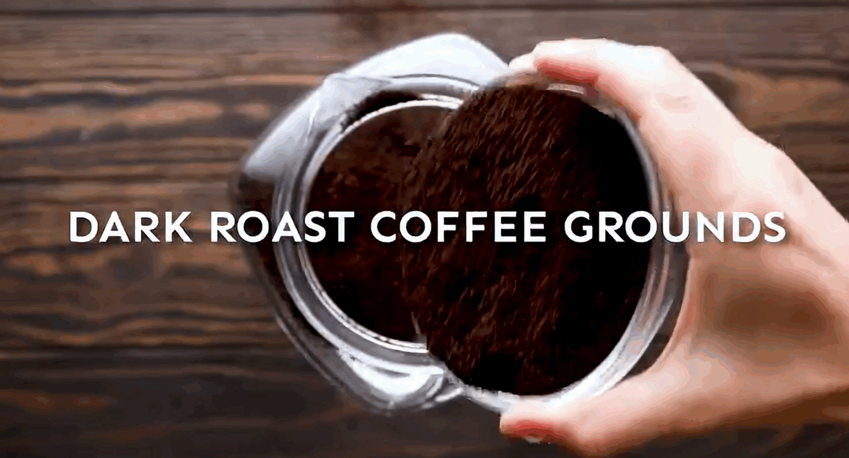 Adding coffee grounds to a pitcher of water. 