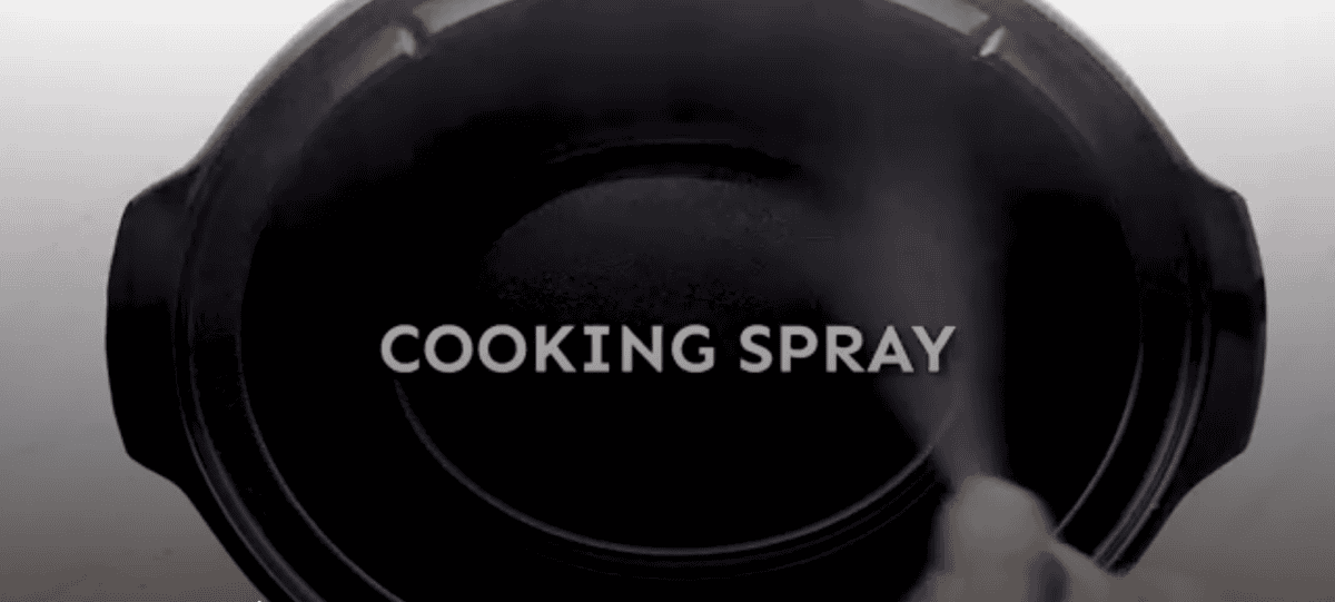 crockpot being sprayed with cooking spray
