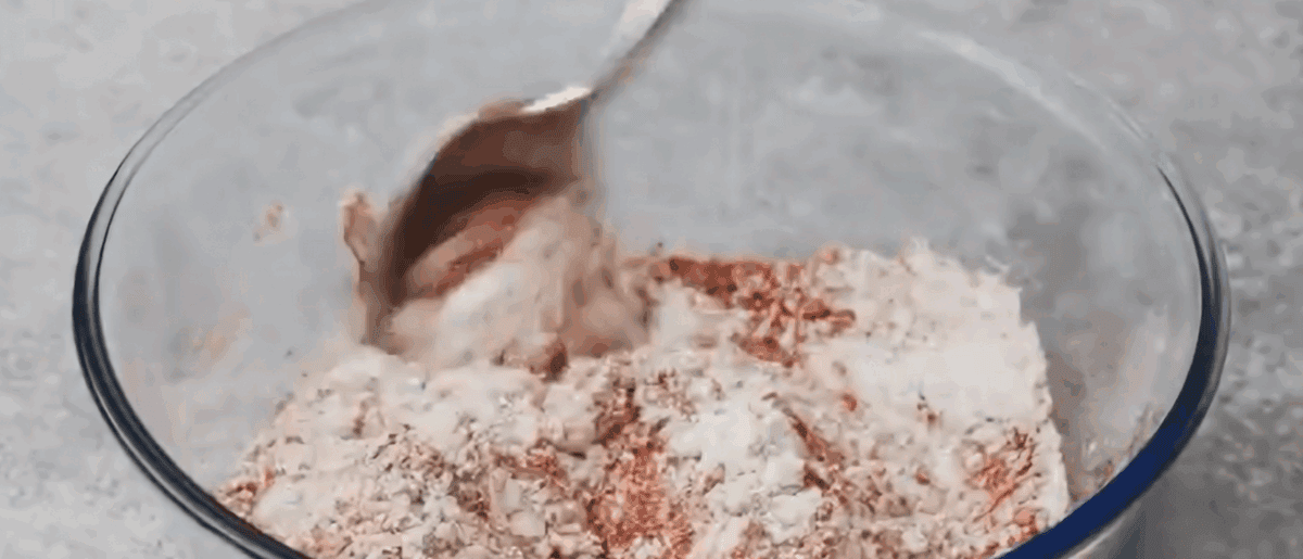 Flour seasoning for the wings in a glass bowl.