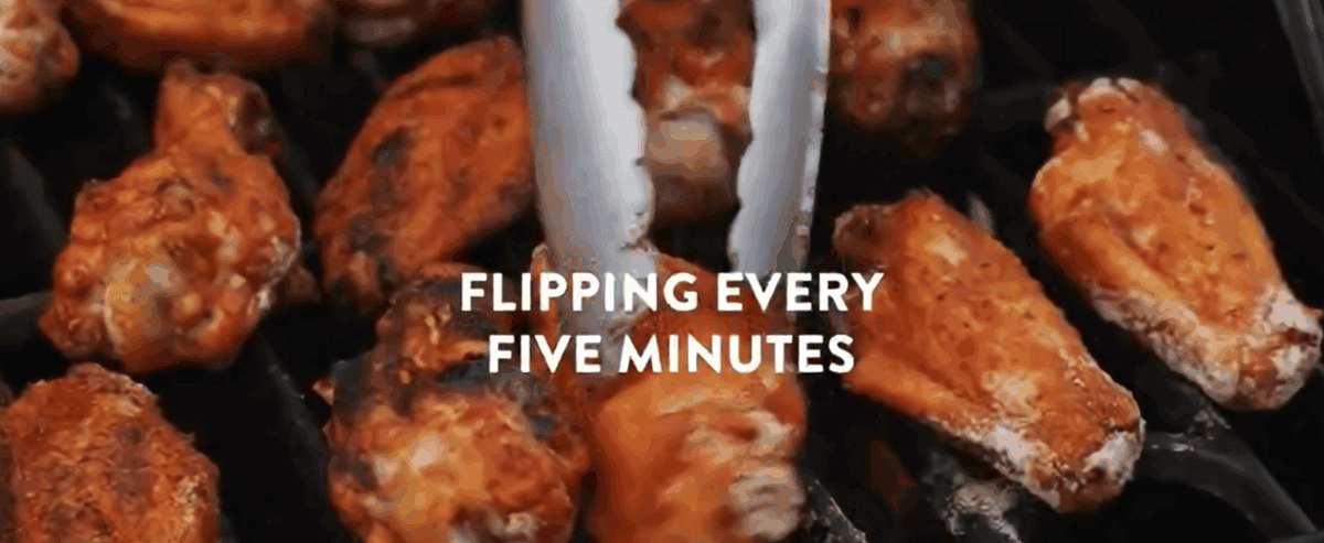 Cooking the wings on the grill. 