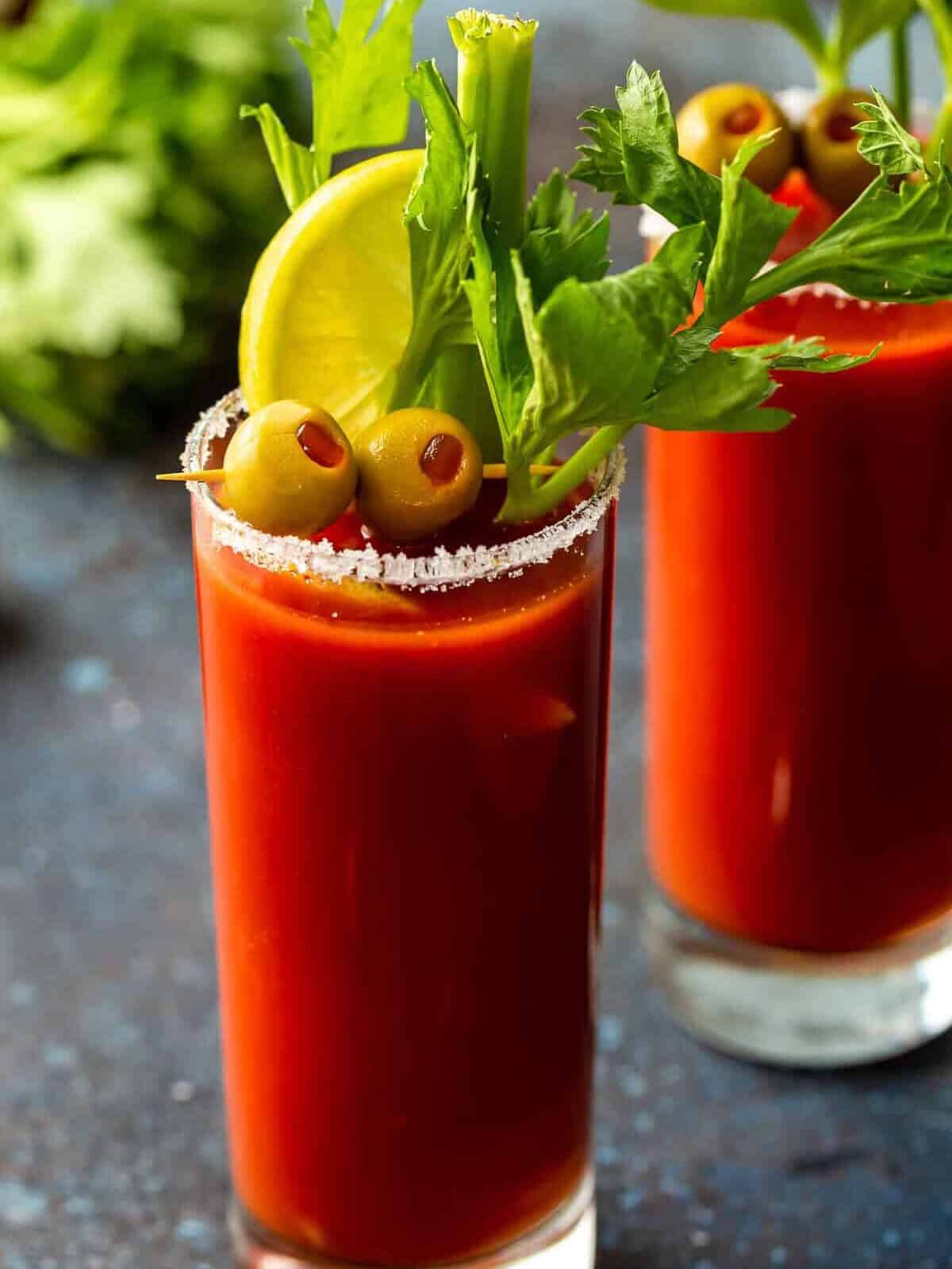 A Bloody Mary is a classic cocktail most of us have heard of, but aren't quite sure how to make. This is the BEST Bloody Mary recipe, and it happens to be really easy. Enjoy this drink with brunch (or use it to cure that hangover). This spicy cocktail is so delicious either way! Bloody Mary cocktails in salt-rimmed glasses