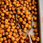 roasted chickpeas on a baking sheet with a spoon.