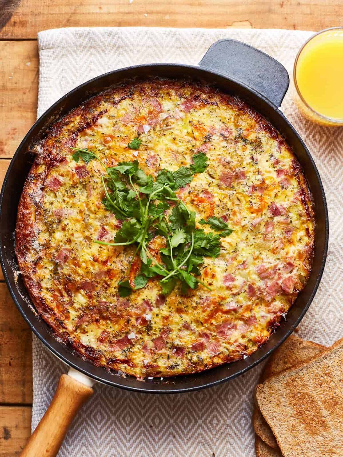 apple ham and cheese frittata in a skillet