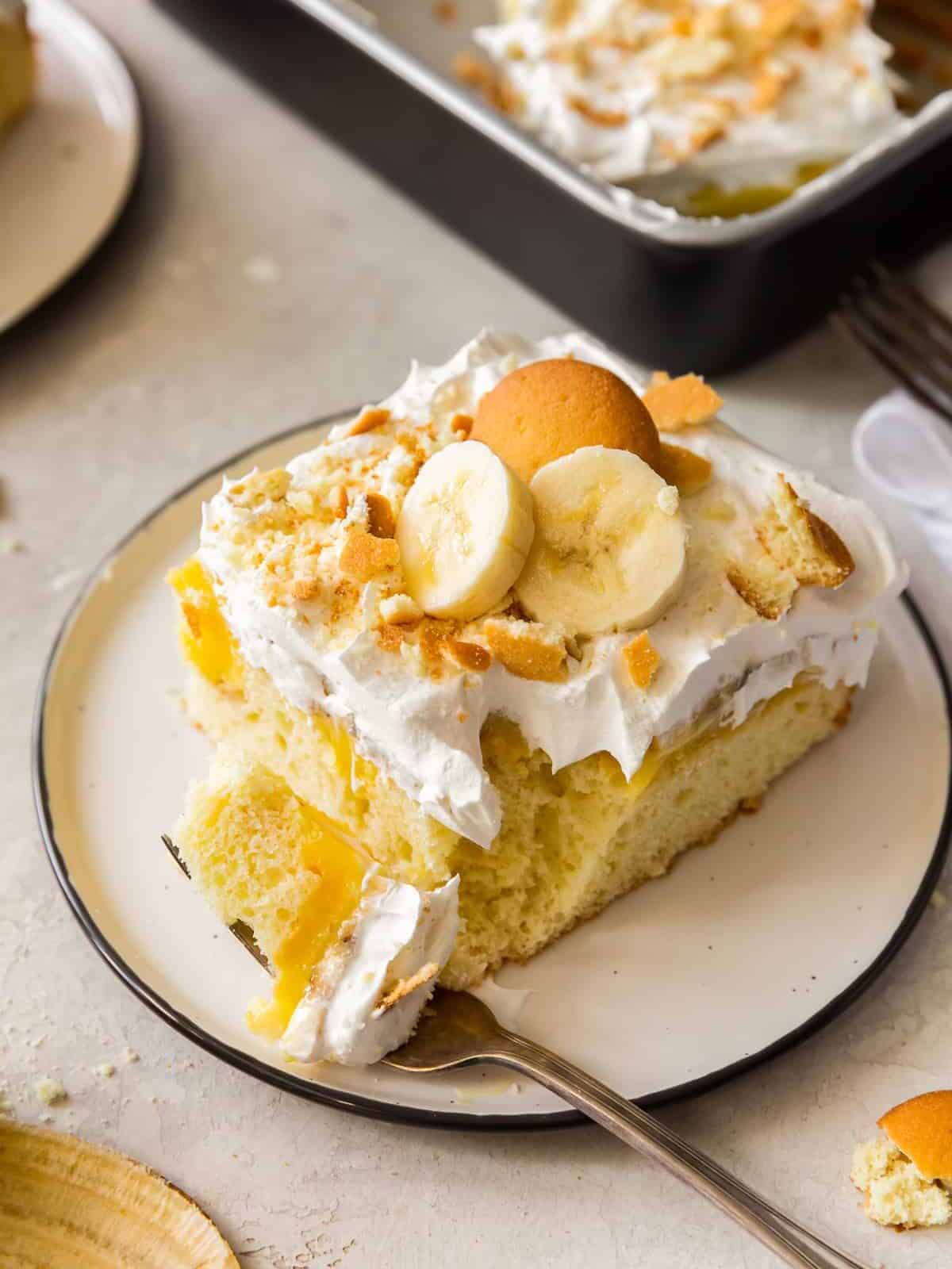 bite out of garnished banana pudding poke cake