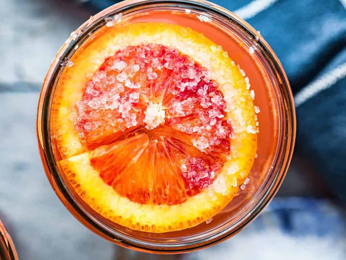 overhead view of a blood orange slice floating on top of a Paloma cocktail
