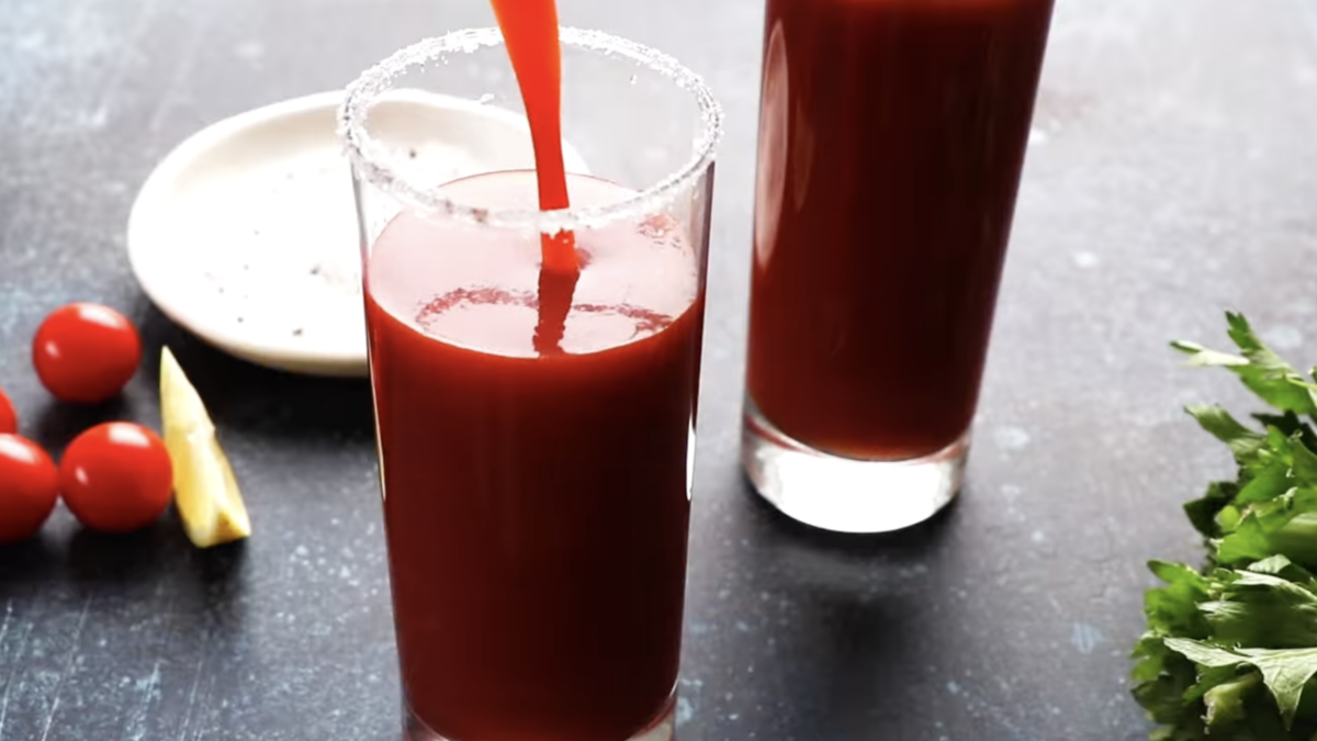 Tomato juice poured into a salt-rimmed glass.