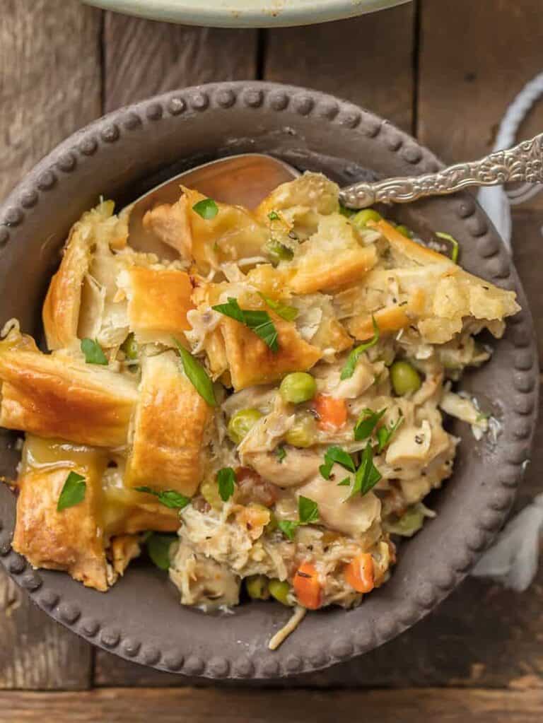 chicken pot pie in a serving dish next to a bowl of it