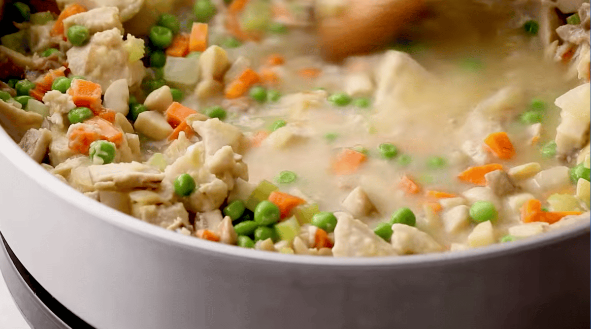 saucy chicken pot pie filling in a pan.