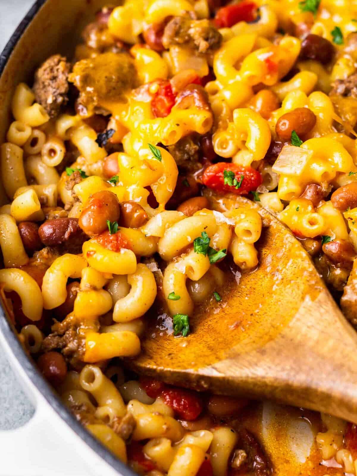 close up on a spoon digging into chili mac