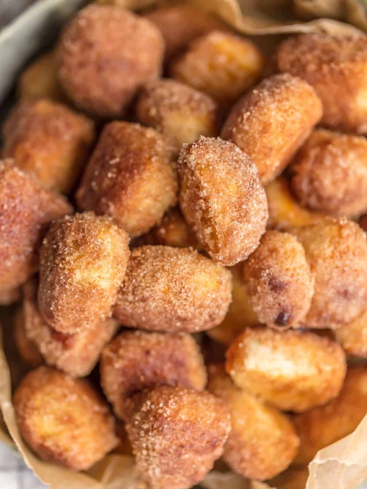 close up on crispy cinnamon bites covered in cinnamon sugar