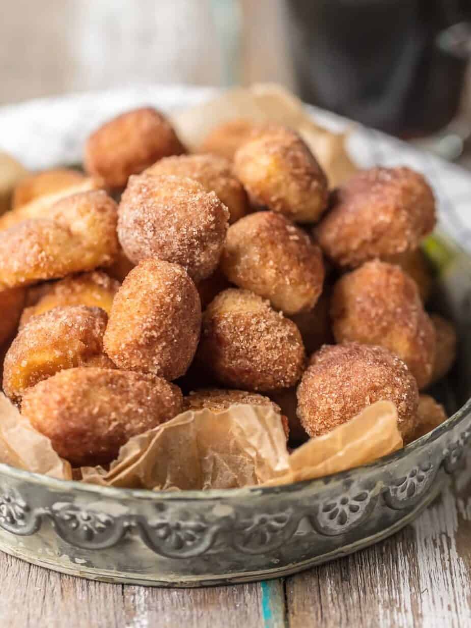 a tray of cinnamon sugar biscuit bites next to a cup of coffee