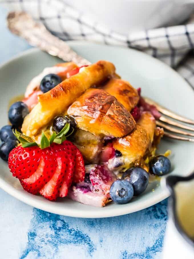plate of croissant French toast casserole with fresh fruit
