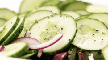 close up of cucumber salad with vinegar dressing.