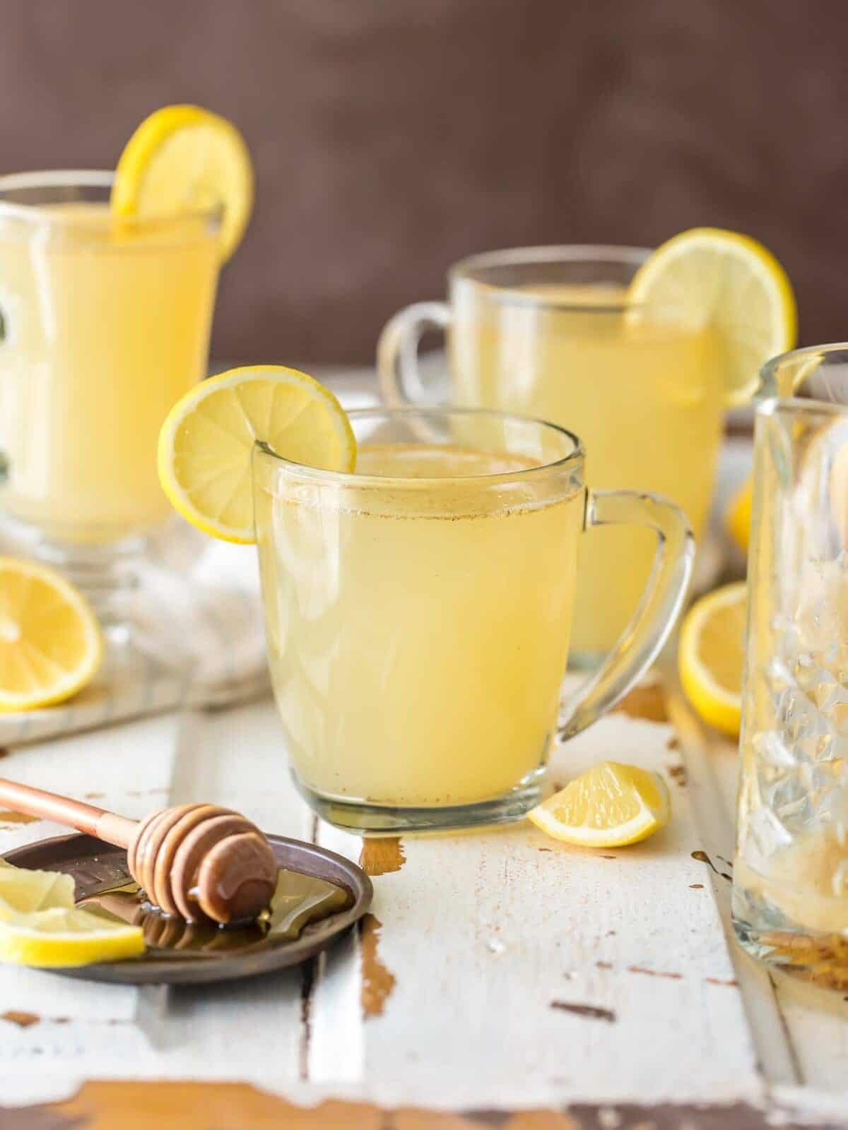 lemon detox water in clear mugs with lemon slices.