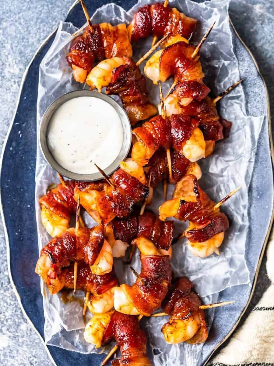 overhead view of a serving platter filled with shrimp wrapped in bacon