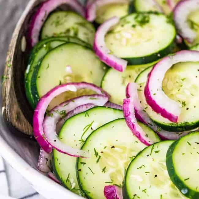cucumber salad in a white bowl