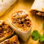 mexican burritos on a wooden board.