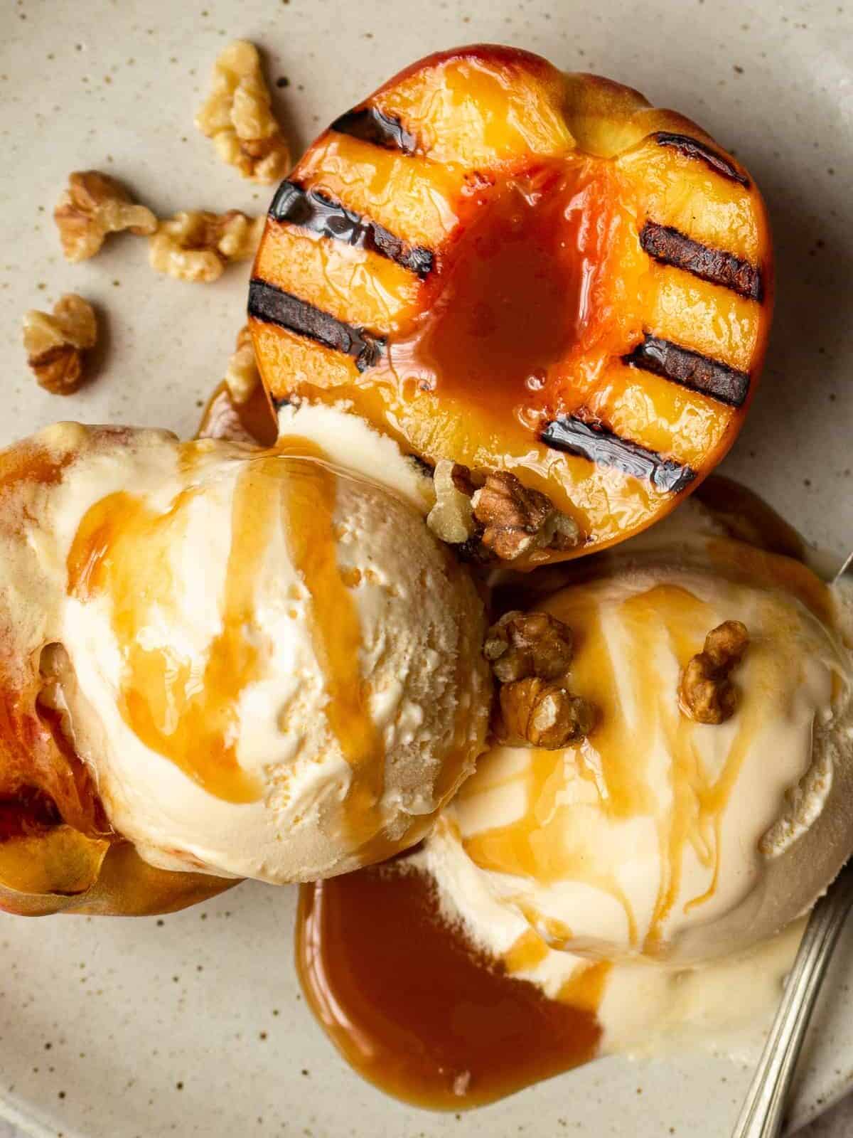 up close grilled peaches with ice cream and caramel sauce