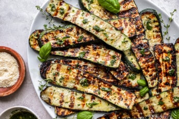 grilled zucchini on a white oval plate.