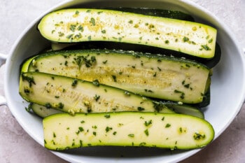 marinated zucchini in a white bowl.