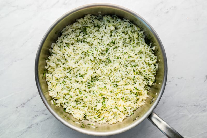 a pan with rice in it on a marble countertop.