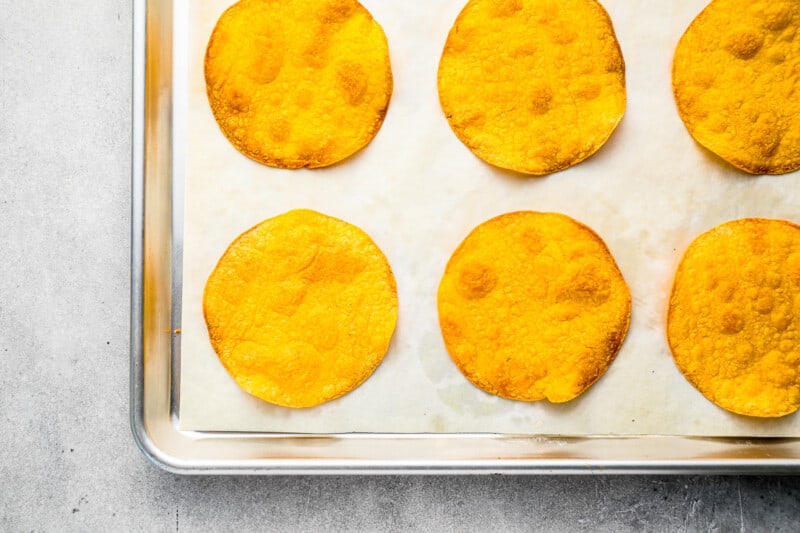 baked corn tortillas on a baking sheet.