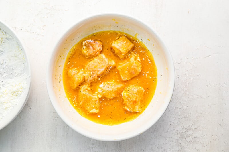 a bowl of chicken curry and a bowl of flour.