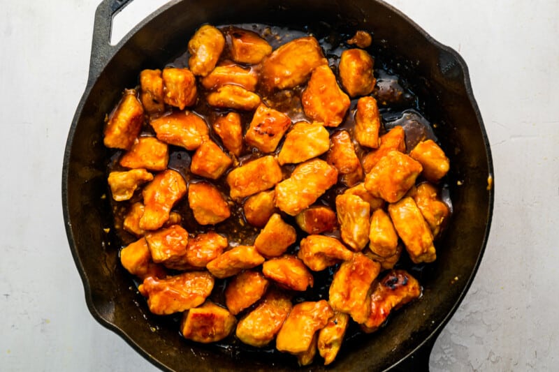 fried chicken in a skillet on a white background.