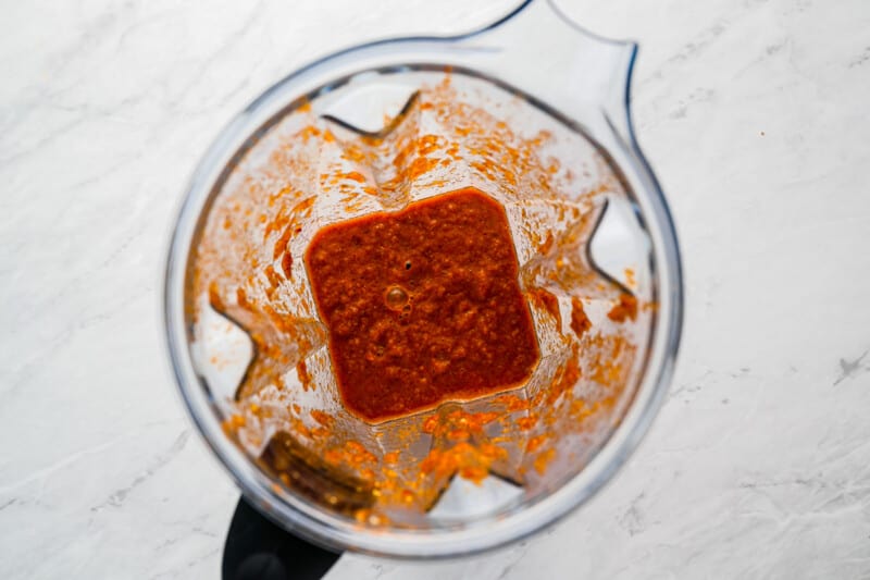 a blender with sauce in it.