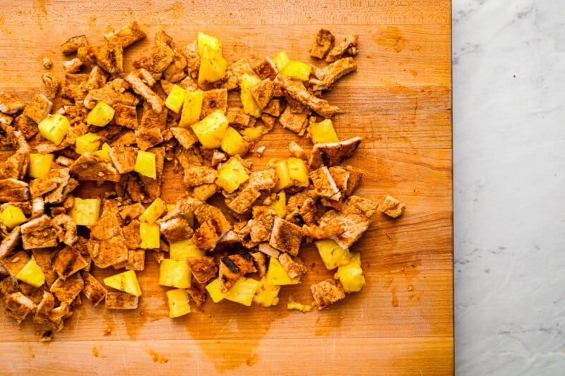shredded pork and pineapple on a cutting board.