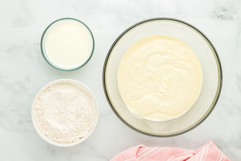 eggs and vanilla added to creamed butter, sugar, and oil in a glass bowl.