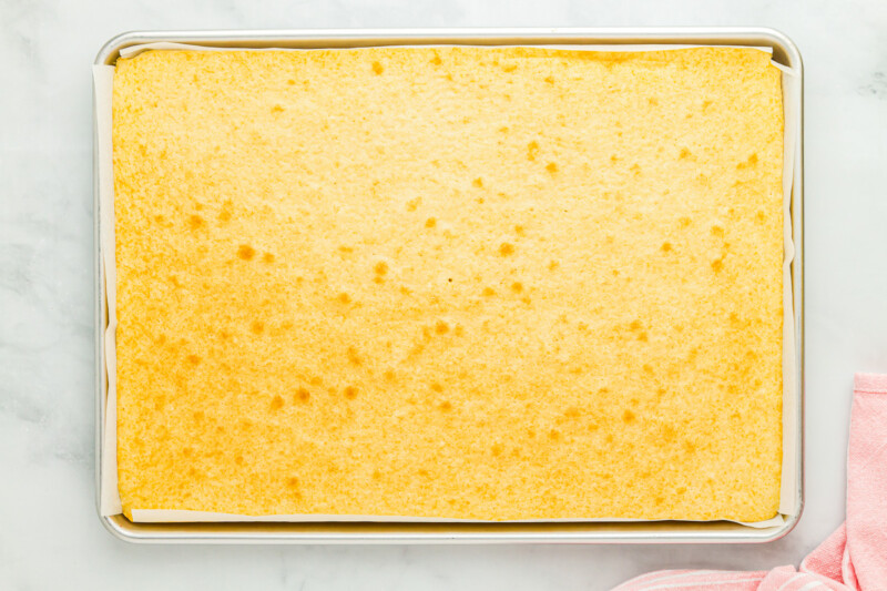 baked vanilla cake in a sheet cake pan.