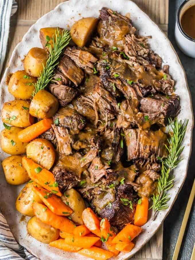 overhead view of a platter of instant pot pot roast with carrots and potatoes