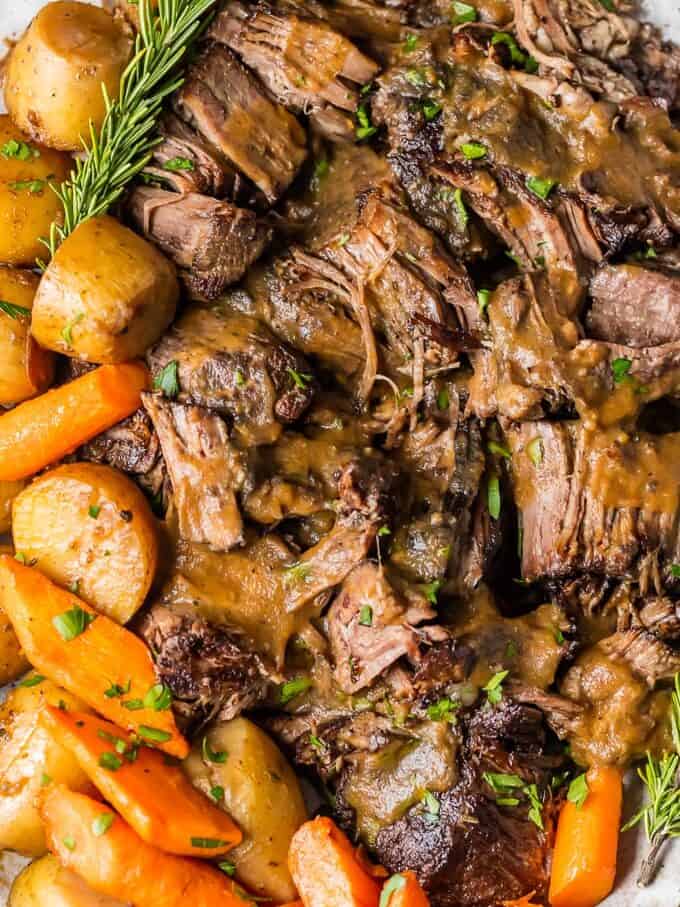 close up on pressure cooker pot roast with carrots and potatoes covered in gravy