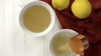lemon juice poured over boiling water in white mugs.