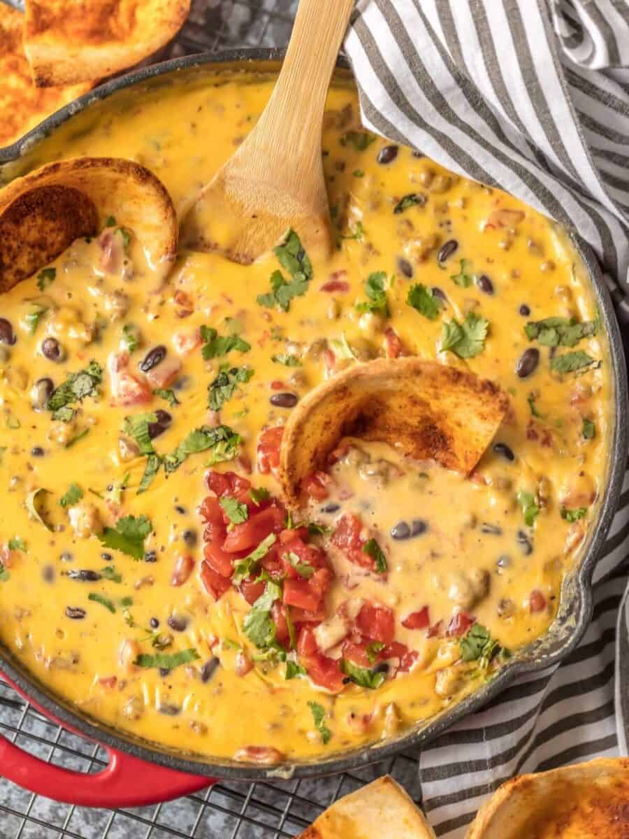 LOADED COWBOY QUESO is the ultimate Super Bowl dip! This EASY appetizer is loaded with velveeta, pepper jack, black beans, Rotel, and sausage! OUR FAVORITE TAILGATING DIP RECIPE!