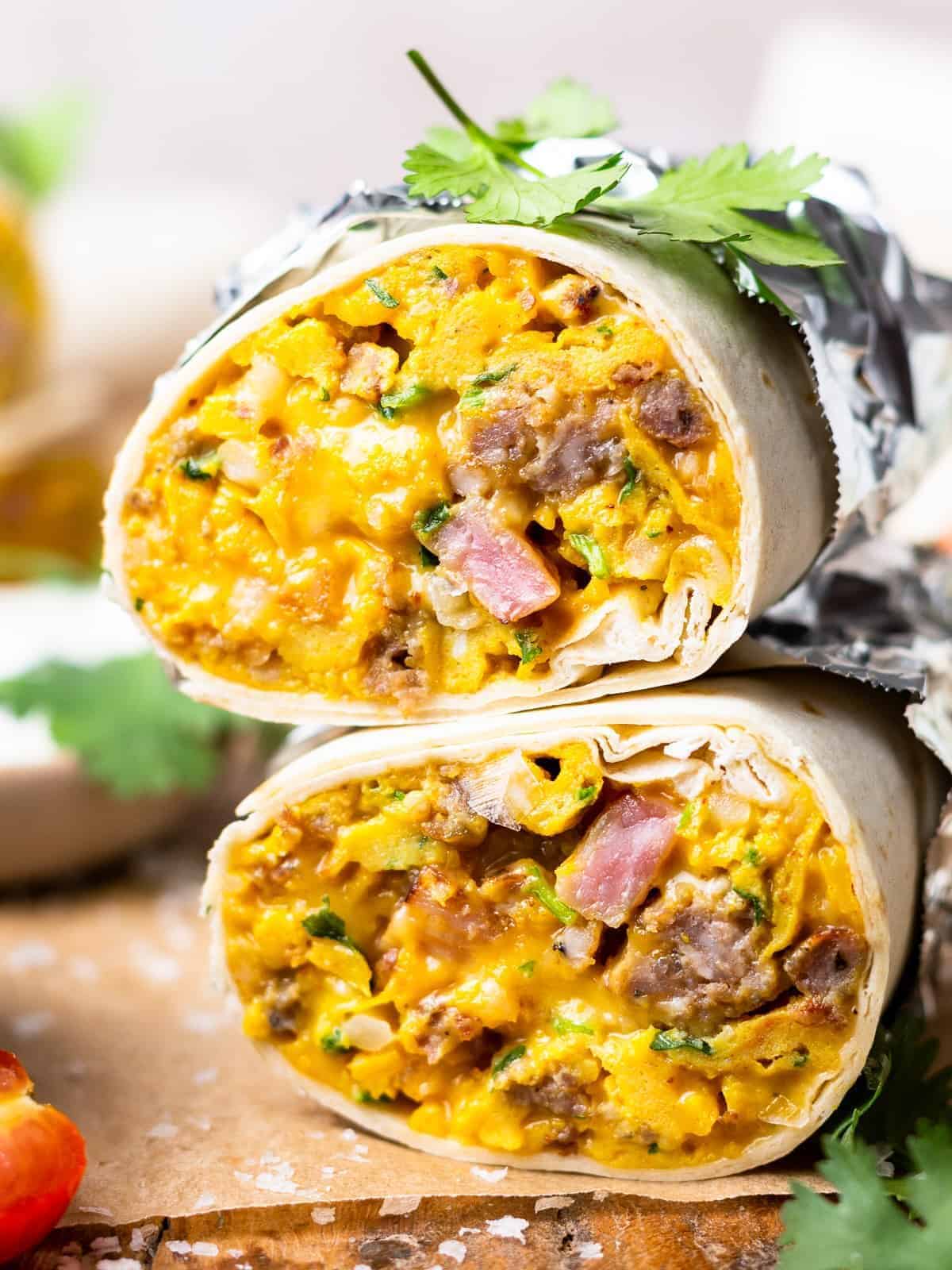 head-on view of a halved make ahead breakfast burrito stacked to show the filling.