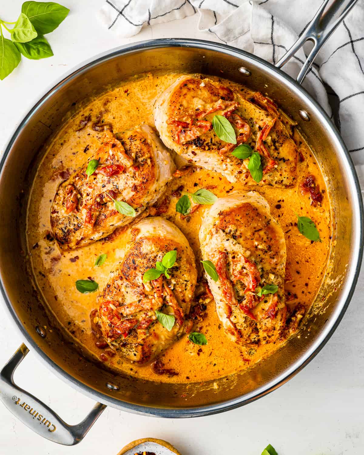 overhead view of marry me chicken in a stainless pan.