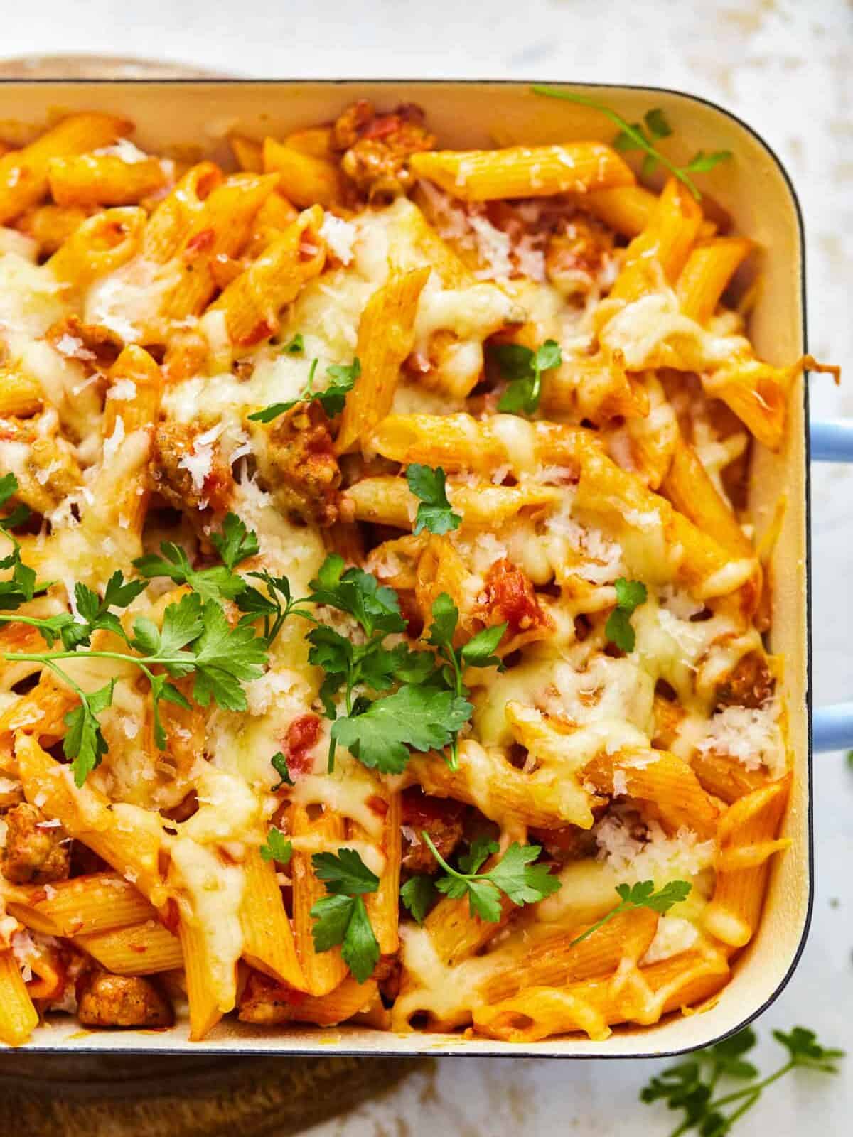 close up on a dish go baked mostaccioli pasta covered in cheese