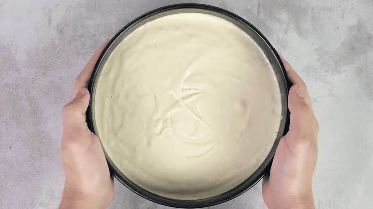 cake batter in a round cake pan.