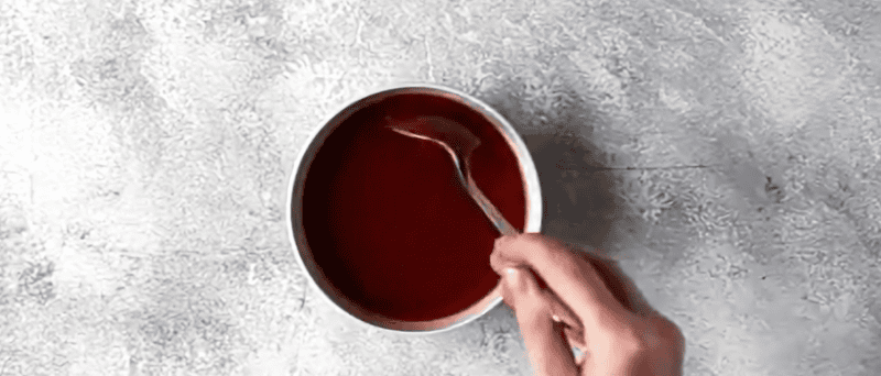 bbq sauce being mixed with liquid smoke.