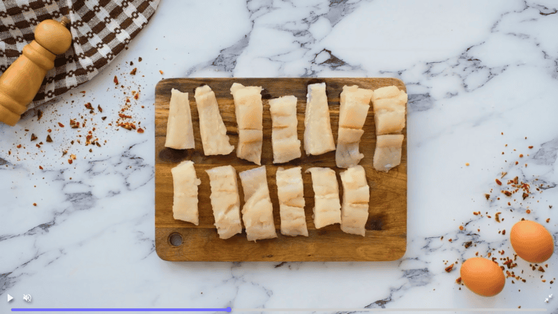 fish cut into strips on cutting board