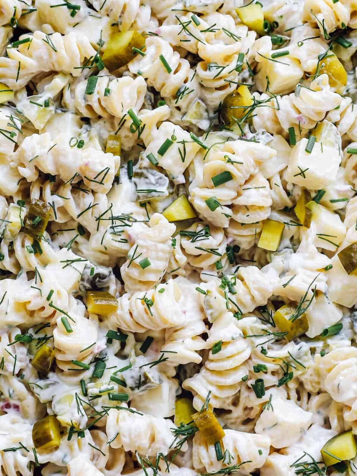 close up on creamy dill pickle pasta salad with mayo dressing