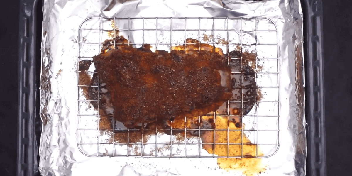 cooked ribs on a rack.