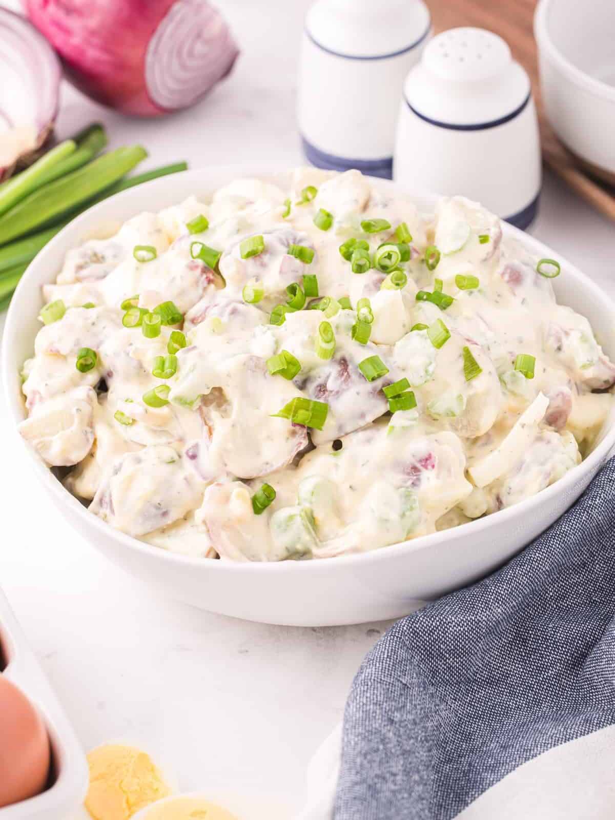 three-quarters view of ranch potato salad in a white bowl.