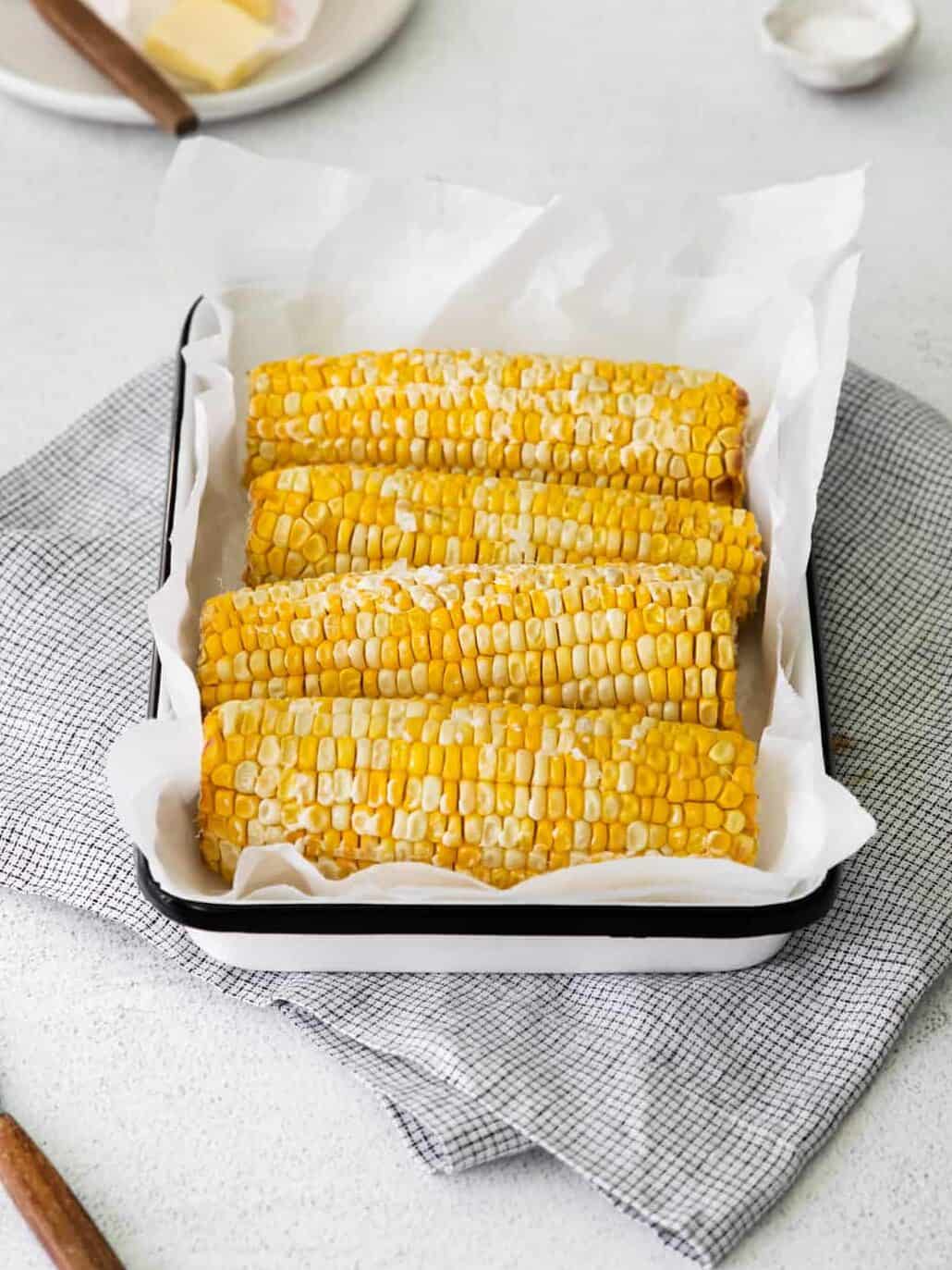 4 ears of corn on the cob on a serving platter