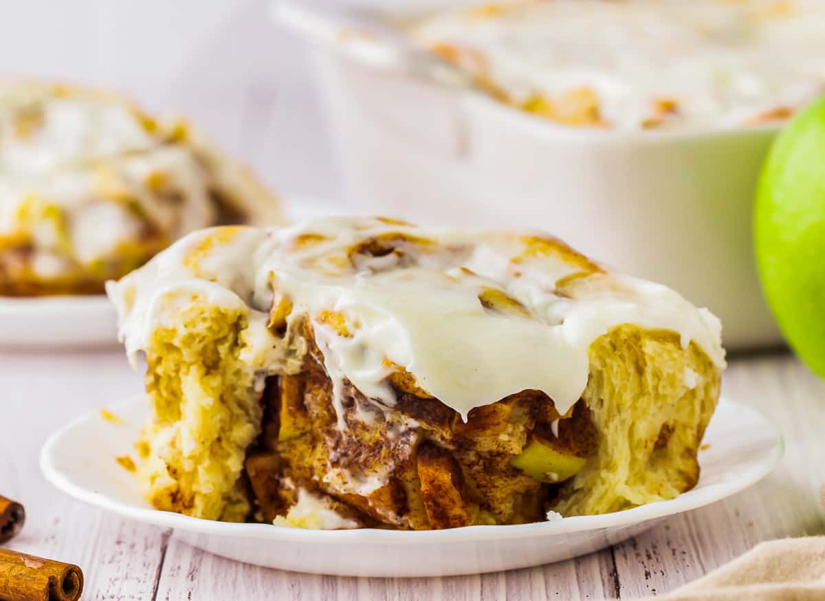 close up on a cinnamon roll with apple pie filling.