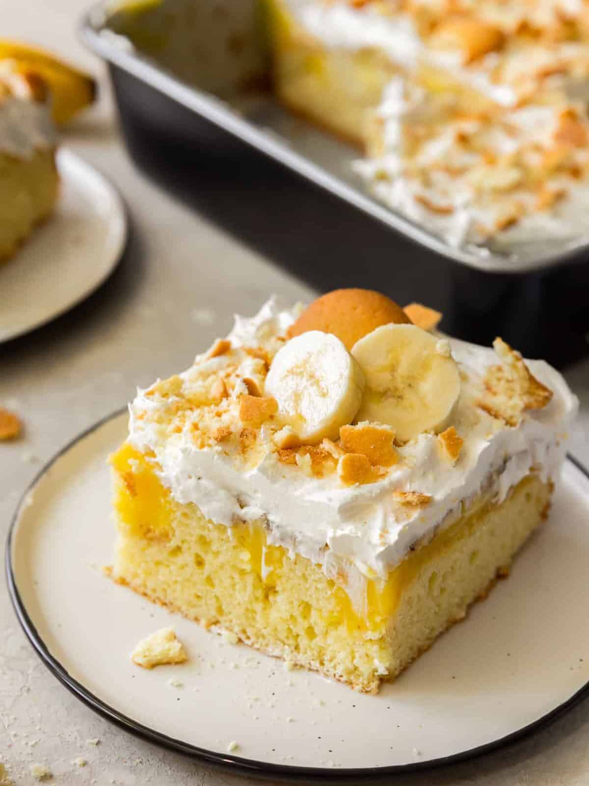 slice of banana pudding poke cake with vanilla wafers