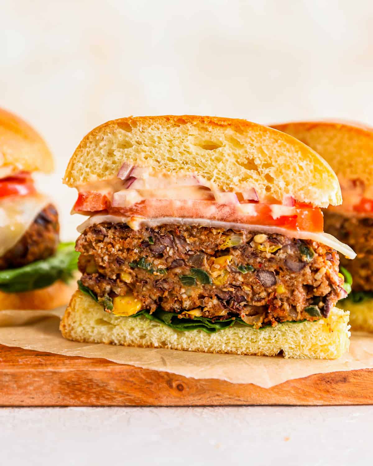veggie burger cut in half to show the patties, filled with black beans, corn, and more.